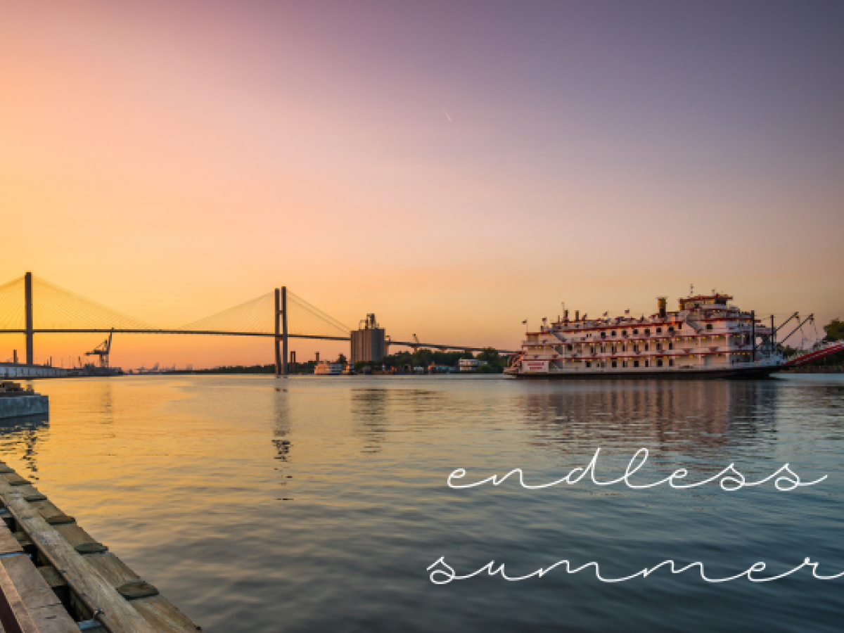 A scenic sunset view of a river with a bridge and a riverboat, with the words 